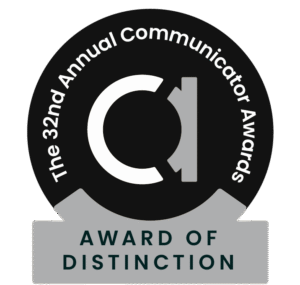 Black. white, and grey circle badge for the 32nd Communicator Awards, Award of Distinction